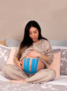 pregnant lady relaxing while wearing blue pregnancy tape. Caption reads "For sensitive skin"