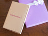 tummytape pregnancy tape packaging leaning against purple gift box