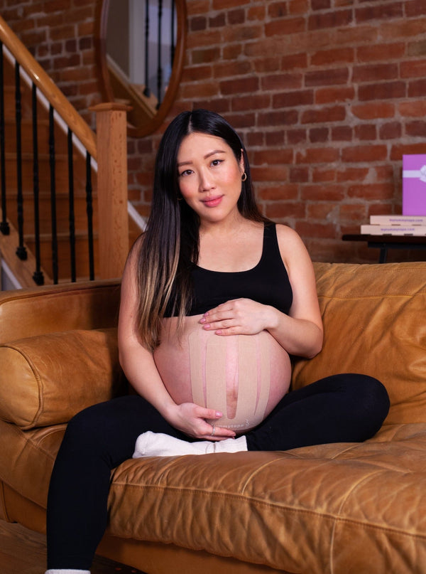 pregnant lady with baby belly supported by beige kinesiology tape. Caption reads "For sensitive skin"